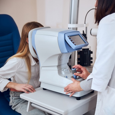 Young girl and optometrist eye test