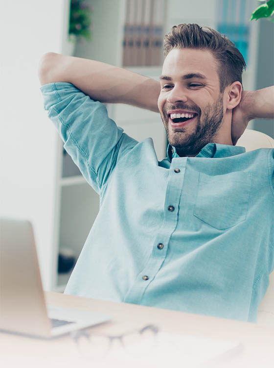 happy-man-at-computer_560x750-1