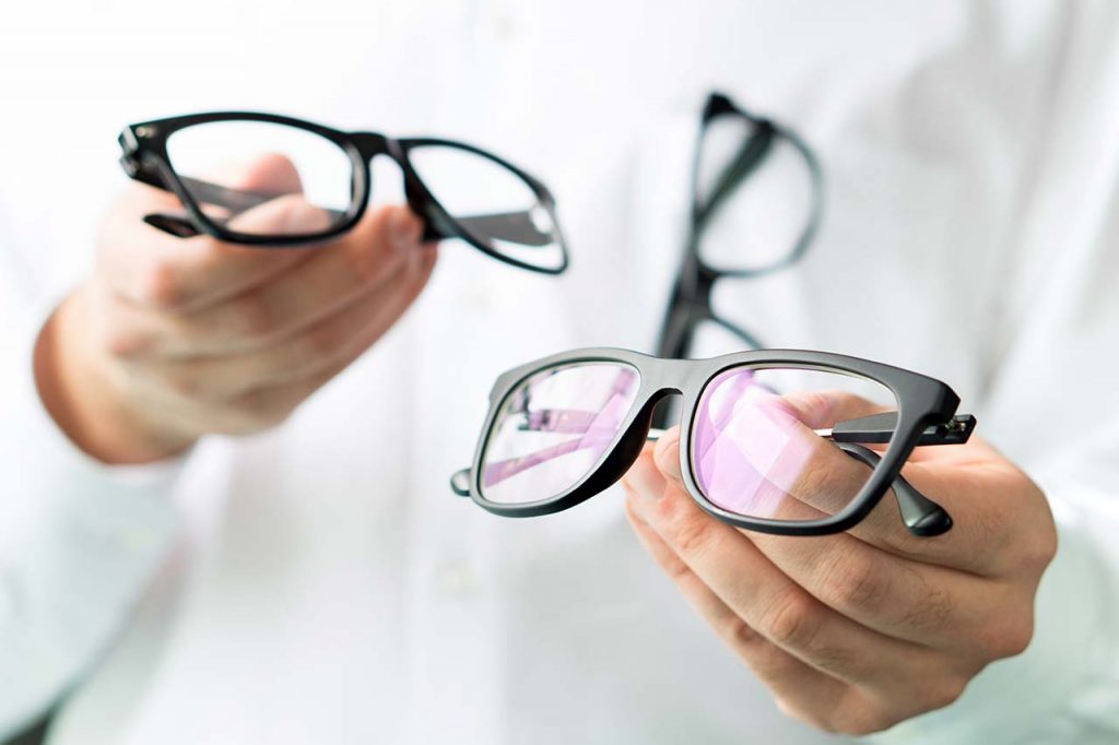 Optician-Holding-Glasses_1280x853-1024x682-1