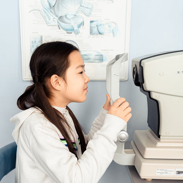 young-Asian-girl-getting-an-eye-exam-facing-left